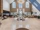Spacious lobby with comfortable seating and a grand chandelier at 1413 Morning Rose Pl, Trinity, FL 34655