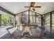 Outdoor kitchen with built-in grill and sink, screened enclosure at 1413 Morning Rose Pl, Trinity, FL 34655