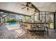 Screened pool area with outdoor kitchen and bar seating at 1413 Morning Rose Pl, Trinity, FL 34655