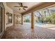 Brick paved patio with access to the pool and screened enclosure at 1413 Morning Rose Pl, Trinity, FL 34655