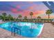 Community pool with a sunset view and plenty of lounge chairs at 1413 Morning Rose Pl, Trinity, FL 34655