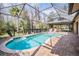 Relaxing kidney-shaped pool with screened enclosure at 1413 Morning Rose Pl, Trinity, FL 34655
