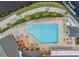 Relaxing pool and clubhouse area with patio seating at 1413 Morning Rose Pl, Trinity, FL 34655