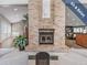 Relax by the cozy fireplace in this inviting seating area at 1413 Morning Rose Pl, Trinity, FL 34655