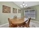 Bright dining room features a wood table, chairs, and large window at 14957 Potterton Cir, Hudson, FL 34667