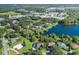 Aerial view of a house near a lake, surrounded by other houses at 1523 Fishing Lake Dr, Odessa, FL 33556