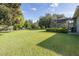 Large backyard with lush grass and screened patio at 1523 Fishing Lake Dr, Odessa, FL 33556