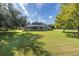Large backyard with lush grass and mature trees at 1523 Fishing Lake Dr, Odessa, FL 33556