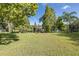 Landscaped backyard with lake and dock view at 1523 Fishing Lake Dr, Odessa, FL 33556