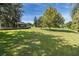Large backyard with green grass and mature trees at 1523 Fishing Lake Dr, Odessa, FL 33556