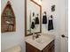 Small bathroom with single vanity and decorative shelving at 1523 Fishing Lake Dr, Odessa, FL 33556