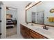 Shared bathroom with double vanity and wood cabinets at 1523 Fishing Lake Dr, Odessa, FL 33556