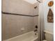 Clean bathroom with tub shower, tile surround, and updated fixtures at 1523 Fishing Lake Dr, Odessa, FL 33556