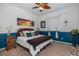 Bedroom with blue walls, ceiling fan, and comfortable bed at 1523 Fishing Lake Dr, Odessa, FL 33556