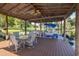 Covered boat dock with seating area and pontoon boat at 1523 Fishing Lake Dr, Odessa, FL 33556