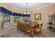 Dining room with wooden table and chairs, and large windows at 1523 Fishing Lake Dr, Odessa, FL 33556