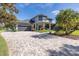 Exterior view of a house with a large brick driveway and lush landscaping at 1523 Fishing Lake Dr, Odessa, FL 33556