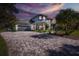 Two story home with paver driveway and American flag at 1523 Fishing Lake Dr, Odessa, FL 33556