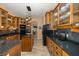 Modern kitchen with dark granite countertops and wood cabinets at 1523 Fishing Lake Dr, Odessa, FL 33556