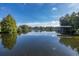 Serene lake view reflecting the sky at 1523 Fishing Lake Dr, Odessa, FL 33556