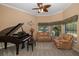 Living area with brown leather furniture, and a grand piano at 1523 Fishing Lake Dr, Odessa, FL 33556