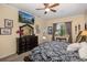 Main bedroom with a large TV, walkout access and lots of natural light at 1523 Fishing Lake Dr, Odessa, FL 33556