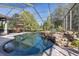 Expansive screened pool and spa with a waterfall feature at 1523 Fishing Lake Dr, Odessa, FL 33556