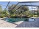 Inviting screened pool with rock waterfall and spa at 1523 Fishing Lake Dr, Odessa, FL 33556