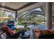 Large, screened pool with patio furniture and grill at 1523 Fishing Lake Dr, Odessa, FL 33556