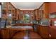 Custom wet bar with wood cabinetry and wine storage at 1523 Fishing Lake Dr, Odessa, FL 33556