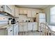 Kitchen with white cabinets, granite countertops, and appliances at 1603 N Gulf N Dr # 30, Bradenton Beach, FL 34217