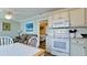 Kitchen view showing living area and bedroom at 1603 N Gulf N Dr # 30, Bradenton Beach, FL 34217