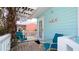 Front porch with seating and tropical plants at 1603 N Gulf N Dr # 30, Bradenton Beach, FL 34217