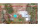 Aerial view of home, detached shed and above ground pool on a large lot at 18923 Rolling Oak Dr, Hudson, FL 34667