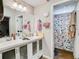 Bathroom with double vanity, large mirror, and shower at 18923 Rolling Oak Dr, Hudson, FL 34667