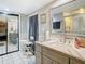 Bathroom with vanity, large mirror, and shower at 18923 Rolling Oak Dr, Hudson, FL 34667