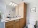 Bathroom with toilet, vanity, and storage cabinet at 18923 Rolling Oak Dr, Hudson, FL 34667