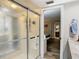 Bathroom with a shower and a view into a bedroom at 18923 Rolling Oak Dr, Hudson, FL 34667