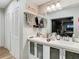 Bathroom with double vanity, linen closet, and access to shower at 18923 Rolling Oak Dr, Hudson, FL 34667