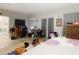 Spacious bedroom with a large bed, dresser, and access to a private bathroom at 18923 Rolling Oak Dr, Hudson, FL 34667