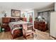 Main bedroom with a large bed and chair at 18923 Rolling Oak Dr, Hudson, FL 34667