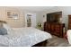 Bedroom with king-size bed, dresser, and view of bathroom at 18923 Rolling Oak Dr, Hudson, FL 34667