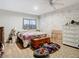 Primary bedroom with king bed, white dresser, and an exposed brick wall at 18923 Rolling Oak Dr, Hudson, FL 34667