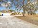 House exterior with a long driveway and landscaping at 18923 Rolling Oak Dr, Hudson, FL 34667