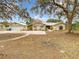 Front view of a ranch-style home with a two-car garage at 18923 Rolling Oak Dr, Hudson, FL 34667