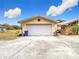 Detached garage with white door and star accent at 18923 Rolling Oak Dr, Hudson, FL 34667
