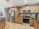 Modern kitchen with stainless steel appliances and wood cabinets at 18923 Rolling Oak Dr, Hudson, FL 34667