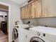 Laundry room with washer, dryer, and cabinets at 18923 Rolling Oak Dr, Hudson, FL 34667