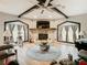 Living room with stone fireplace, wood beams, and a large sectional sofa at 18923 Rolling Oak Dr, Hudson, FL 34667