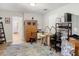 Office area with wooden cabinet, desk, and view of the bathroom at 18923 Rolling Oak Dr, Hudson, FL 34667